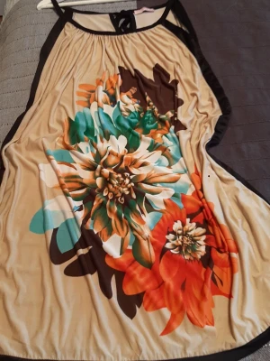 Beautiful dress for summer - Unique pattern with colourful flowers in orange, blue, white and brown on a beige base... magical, not overwhelming... with lightweight material. Excellent condition. Measurements on pictures.  I think fits for size L-XL.