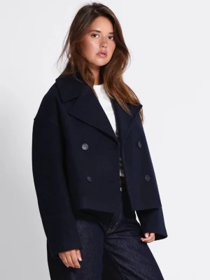 Mörkblå skepparkavaj med bred krage - Stilren mörkblå skepparkavaj med dubbelknäppning och bred krage. Jackan har en boxig, något kortare passform och stora knappar framtill. Tillverkad i ett tjockare tyg som ger en klassisk look. Perfekt för dig som gillar tidlös och enkel stil.