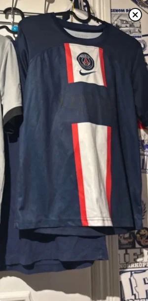 PSG Neymar matchtröja blå - Säljer en blå PSG matchtröja från Nike med Neymar och nummer 10 på ryggen. Tröjan har vita och röda detaljer framtill samt PSG-logga och Nike-swoosh på bröstet. Perfekt för dig som älskar fotboll och vill stötta Paris Saint-Germain.