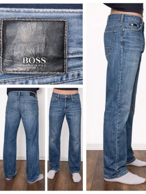 Hugo Boss Jeans - TEXAS - Hugo Boss jeans – TEXAS (W32 L32)  Classic Hugo Boss Texas jeans with a style from the late 1990s / early 2000s, a time when Boss was known for understated luxury and perfect fit. A straight, timeless silhouette made from 100% cotton with an authentic denim feel. Mid-blue wash that works with everything and ages beautifully. For those who appreciate quality and style that lasts. Feel free to get in touch with us if you have any questions.