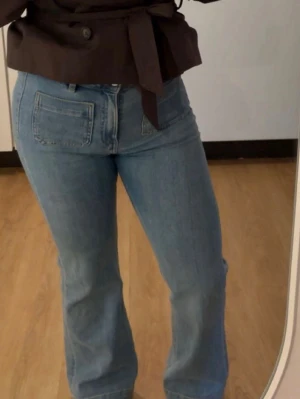 Ljusblå bootcut jeans med fickor - Säljer ett par superfina ljusblå jeans i modellen “Camille” 🌟 Storlek: W28 L30.  Jeansen sitter väldigt snyggt och formar kroppen fint med lätt bootcut nertill. Bekvämt stretchigt material och perfekt vardagsjeans som passar till allt. Använda få gånger och i fint skick. 💙