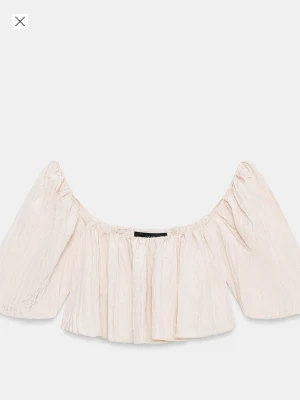 Offshoulder vit blus med volang - Superfin offshoulder blus i ljusvit färg med volangdetaljer och vida ärmar. Perfekt för dig som gillar en luftig och trendig stil. Blusen har en lös passform och ärmlös design över axlarna.