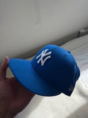 New Era fitted keps  - Yo, säljer denna lila fitted keps. Kepsen är i jätte bra skick och är i storlek 57.7cm och är en hyfsad ”standard” storlek. Denna keps har även en ”grey brim” som det kallas villkor är lite svårare att hitta idag!