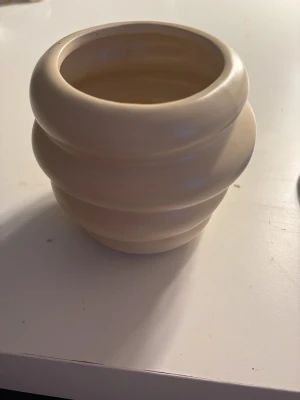 Set med sminkborstar i beige hållare - Säljer ett set med flera sminkborstar i olika storlekar och former, perfekta för både bas, ögonskugga och contouring. Borstarna har mjuka borst och handtag i rosa och metall. Medföljer gör en beige, rundad borsthållare i keramikliknande material som ger en snygg look på sminkbordet.