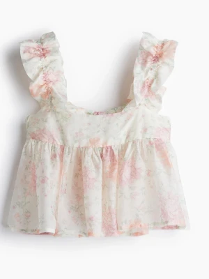 Blommig volangtop med breda axelband - Supersöt blommig linnetopp i ljusa pastellfärger med volangdetaljer på de breda axelbanden. Toppen är ärmlös och har en luftig, flowy passform. Perfekt för varma dagar och ger en romantisk vibe till din outfit.