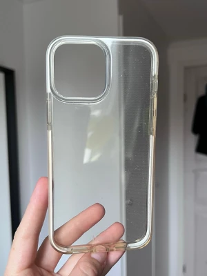 Transparent mobilskal från Holdit (iPhone 13 Pro Max) - Säljer ett stilrent och genomskinligt mobilskal. Perfekt för att skydda din telefon utan att dölja dess design. Skalet har exakta utskärningar för knappar och kamera. Sparsamt använt. iPhone 13 Pro Max!