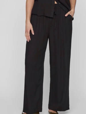 Svarta vida linnebyxor med dragsko - Säljer ett par svarta linnebyxor med avslappnad passform och dragsko i midjan. Byxorna har raka, vida ben och elastisk midja för extra komfort. Perfekta för en chill och stilren look.