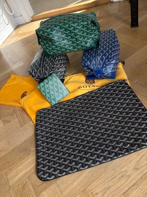 Väskor i olika färger  - Säljer flera  handväskor i grönt, blått, svart och grått med det klassiska mönstret. 3 neccesärer och 1 datafodral och en plånbok. Kom privat för mer info och diskussion om pris mm.