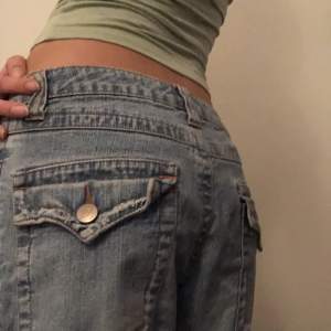 Lågmidjade jeans med coola fickor! Köpta secondhand och är i bra skick. Tyvärr har dom gått upp lite längst ner på baksidan av vänstra benet, men det syns inte när jeansen är på💛 midjan rakt över: 32 cm, Ytterbenslängd: 95 cm💛