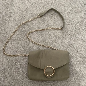 Grön axelremsväska - Grön väska med guldiga detaljer och 2 fack