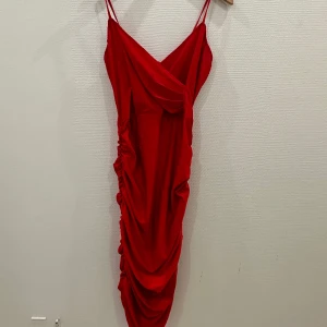 Red ruched midi dress - Beautiful “true red” bodycon  dress  in slinky fabric, simply dress it up with heels and some statement jewelry. Brand new, not worn.  BRAND: AX Paris 