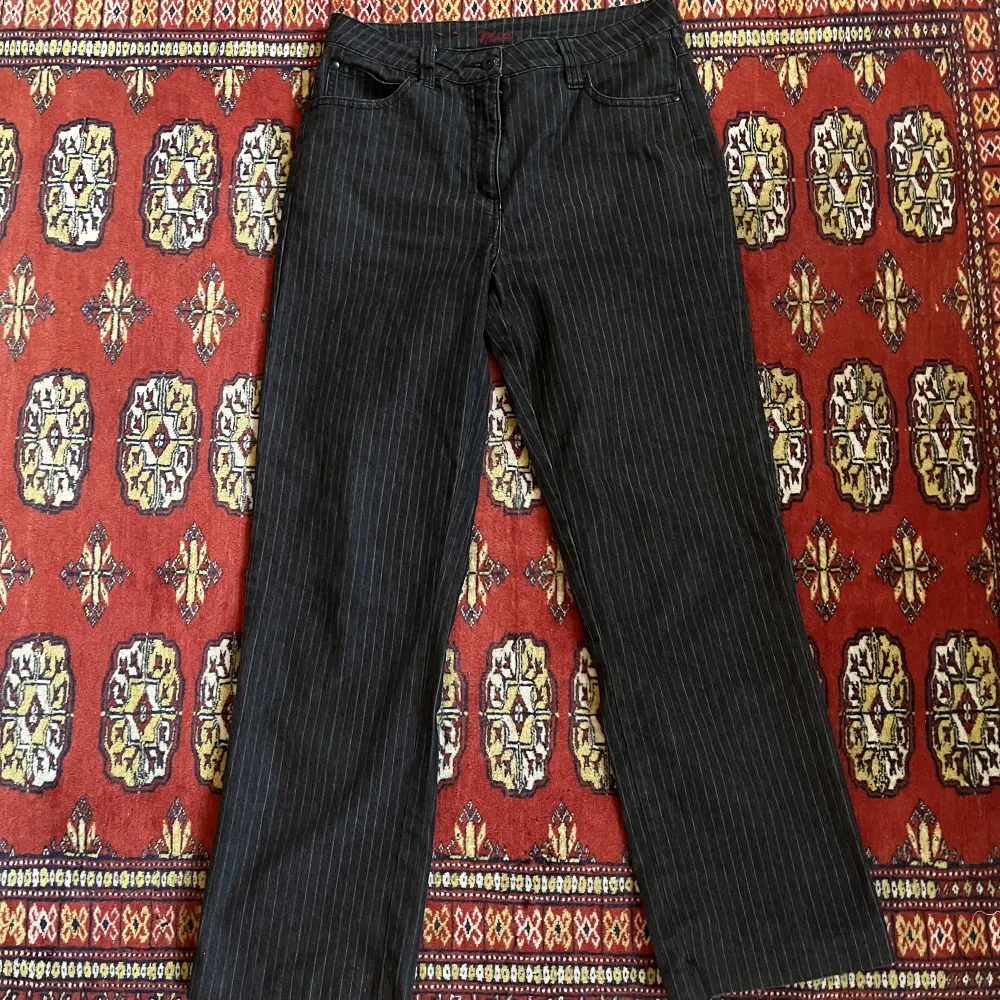 Ett par mid rise svarta jeans med vita ränder Midjemått: ca 74cm Innerbenslängd: ca 71cm (sitter lagom på mig som är ca 162). Jeans & Byxor.