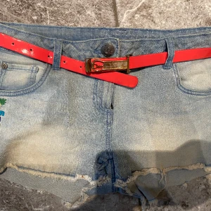 Jeansshorts  - Använda jeansshorts. Coola färgglada detaljer. Bältet inkluderas också i priset. Säljer pga stor garderobrensning. Kika gärna på mina andra annonser, säljer mycket. Samfraktar gärna:) 