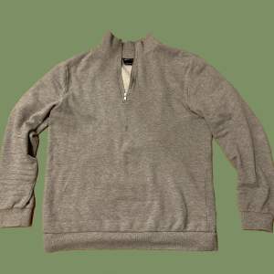 Långärmad grå tröja med fleece-liknande foder, dock inte lika varm som riktig fleece. Bra skick och sparsamt använd. 
