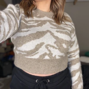 Croppad stickad tröja - Säljer min croppade stickad tröja i zebra mönster som är från SHEIN. Den är knappt använd. Är väldigt fin och tjock i materialet, den sticks inte heller när man har på sig den. Väldigt varm och skönt!