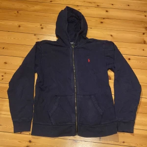 Polo Ralph lauren zip hoodie  - En snygg Polo Ralph lauren zip hoodie. Ganska använd och har fått en liten missfärgning längs med dragkedjan. Annars mycket bra skick. Storlek S