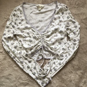 Topp  - En blommig topp från h&m som man kan dra åt där fram