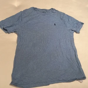 Ralph lauren T-shirt  - Ralph lauren T-shirt i en snygg blå färg. Står XL (barn) det kan motsvara XS. En perfekt tillskott i garderoben! Först till kvarn.