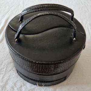 Smyckesskrin  - Svart smyckesskrin i fejkläder. Många fack. Observera att det är i använt skick Kan hämtas i Helsingborg 