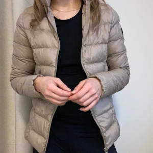 Jacka XS - Beige tunn dunjacka pufferjacka från Hampton Republic Kappahl, storlek 32/34.  Några fläckar som ej går bort i tvätten, se två sista bilderna. De syns inte så bra då de är nästan samma färg som jackan :)