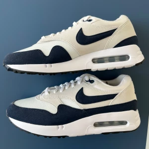 Nike Air Max 1 vita och marinblå sneakers - Nike Air Max Golf sneakers i vitt och marinblått. Helt oanvända och i perfekt skick!! Tycker inte riktigt de passar till mig så säljer dem. 