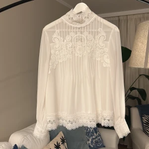 Ursnygg Ted Baker blus - En vit, stilren, elegant och klassisk vit blus med spets. Passar en ung tjej och en dam. Använd max 1-2 gånger. Nypris: 2000kr. Size 2 som passar storlek 34 men eftersom den är luftig passar den dessutom nån med storlek 36