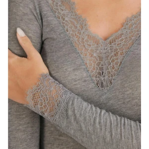 Grå intimissimi topp med spetsdetaljer - Säljer en grå långärmad intimissimi topp med v-ringning och fina spetsdetaljer vid halsringning och ärmslut. Tunn och mjuk, perfekt att styla lager på lager eller som den är. Snygg och feminin look. Storlek S, aldrig använd. Superfint basplagg för garderoben. Går att klä upp och ner. Superfint!! Tryck gärna på köp nu!💓