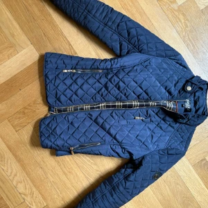 Jacka  - Säljer min fina marinblå jacka med gulddetaljer ifrån Holister, den är storlek 38 men passar en 36:a mycket fint skick!