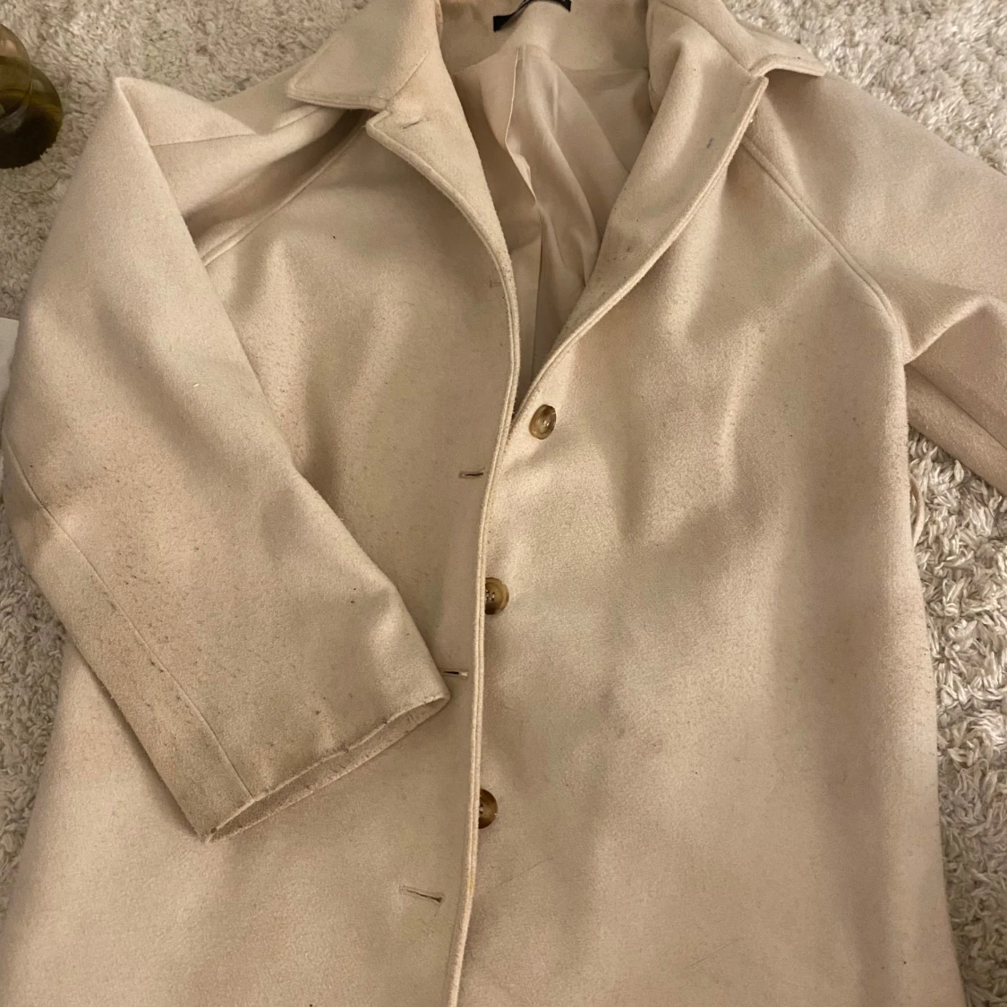Beige kappa från Gina Tricot