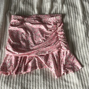 Rosa blommig kjol från SHEIN - Supersöt rosa kjol från SHEIN med små vita blommor och volangdetalj. Användt typ 3 gånger men säljer nu för att den aldrig kommit till användning och inte min stil nu mera. Den är super skön och är till låren ungefär i längd, skriv om ni har frågor 🩷