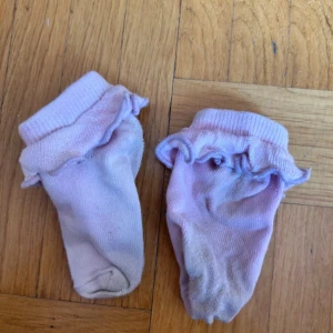 Ljusrosa strumpor med volangkant - Söta ljusrosa strumpor med volangkant upptill. Perfekta för dig som gillar gulliga detaljer och vill ha något extra till outfiten. Mjukt material som känns skönt mot huden.