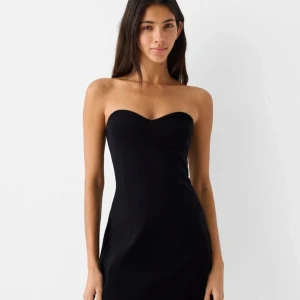 Svart axelbandslös klänning  - Supersnygg svart bandeau-klänning från Bershka. Aldrig använd lappen sitter kvar.