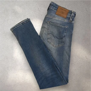 Blå Jack & Jones Slim Glenn jeans - Snygga blå jeans från Jack & Jones, modell Slim Glenn. Jeansen har en slim passform med smalare ben och klassisk femficksdesign. Personen på bilden är 180 cm lång och väger 63 kg. Skicket är mycket bra, skriv vid frågor!