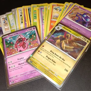 Pokémonkort 25st (+ 2st reversed holos) - Blandade kort - Samling Pokémonkort med coola motiv, inklusive Tapu Lele och Haxorus. Perfekt för dig som vill bygga din egen lek eller samla på unika kort. Färgglada och i fint skick – ett måste för alla Pokémonfans!