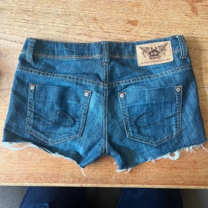 Lågmidjade jeansshorts - Jätte snygga lågmidjade jeansshorts, med coolt tryck på fickorna och fina detaljer. Det är ett litet sprun längst ner på benens sidor. Dom är från edc by esprit. Och midjemåttet rakt över är 39 cm❤️