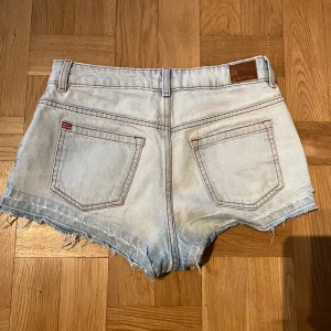 Ljusblå lowwaist jeansshorts från BDG - Säljer ett par ljusblå jeansshorts från BDG. De är lågmidjade och man kan använda dem som vanligt eller vika ner dem (bild 2)🥰 de är sååå snygga på båda sätten 