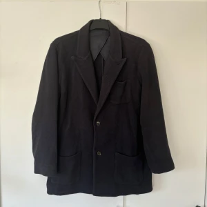 John Henric kavajjacka - Snygg elegant populär mörkblå kavajjacka från John Henric i storlek M (axelbredd på 44 cm) säljes. Perfekt att använda som cardigan för dig som är stilmedveten. Tveka inte vid minsta fråga eller fundering och pris ej hugget i sten😃