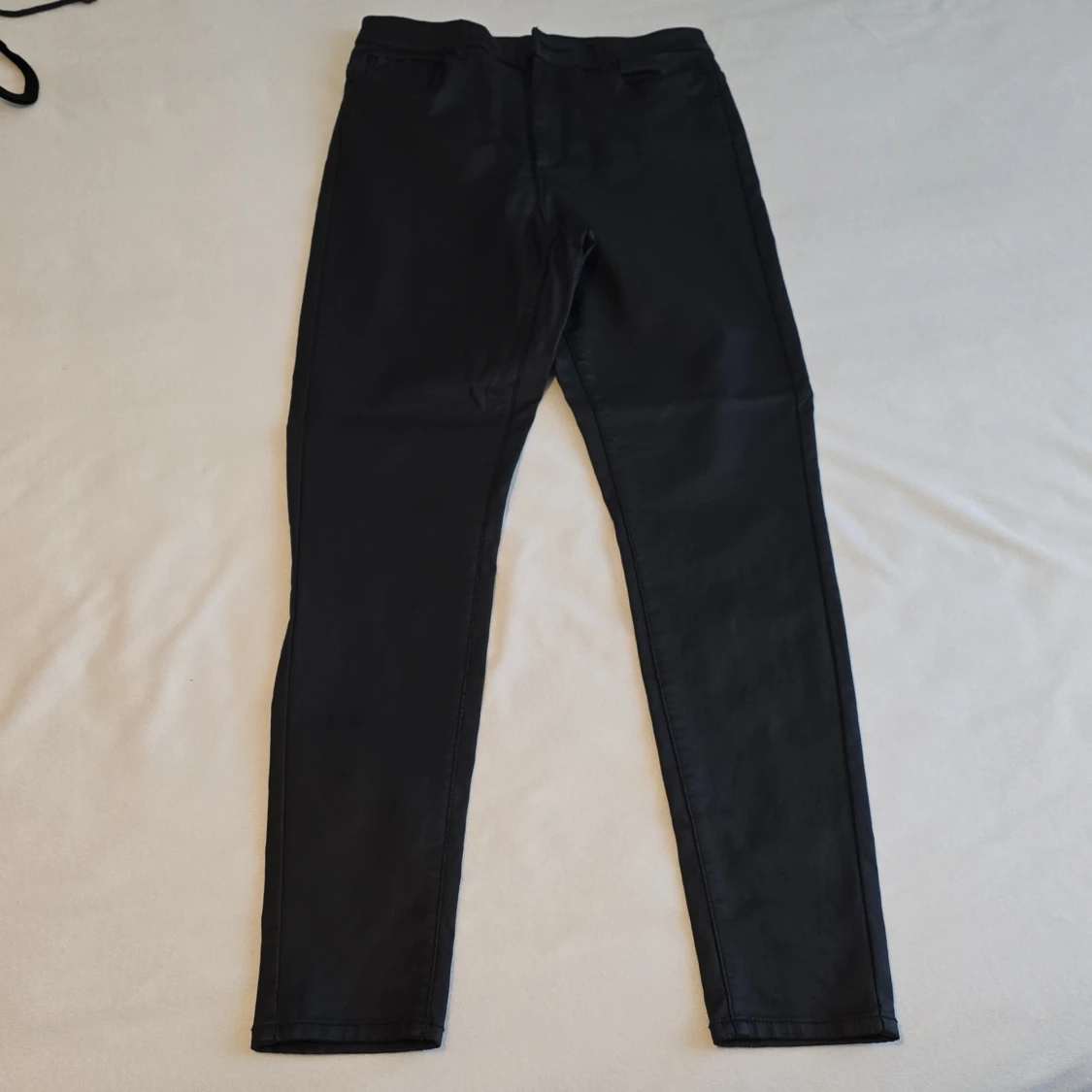 Svarta byxor i syntetmaterial