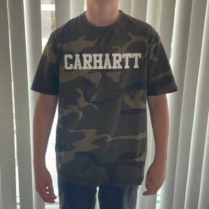 Camouflage t-shirt från Carhartt - Säljer en cool camouflage t-shirt från Carhartt med stort tryck på bröstet. Perfekt för en avslappnad stil. Storlek M och skicket är 8/10! Passar kanske mer S