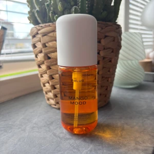 Phlur Mango Mood parfymmist - Fräsch parfymmist från Phlur i doften Mango Mood. Flaskan är genomskinlig med orange vätska och har en stilren vit kork. Perfekt för dig som gillar fruktiga och tropiska dofter. Passar både hår och kropp. Ny
