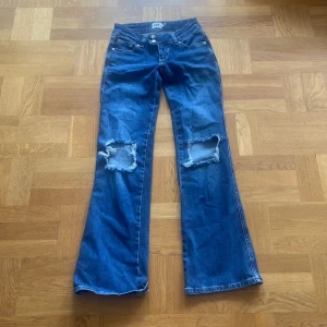 Blå bootcut jeans från 157 Paris Core - Snygga blå bootcut jeans från Lager 157 med slitna hål över knäna och en liten detalj på byxfickan som man kan se på bilden 💗Säljer då dom tyvärr är för små på mig 😢Storlek XS. Jag har bara använt dom ett fåtal gånger, så inget synligt slitage på dom 💗Köpta för 400 säljer för endast 150 kr💗