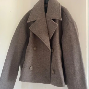 Beige/Brun kappa🤎 - Säljer en  beige/brun kappa från lager 157 i storlek XS. Jackan har en dubbelknäppt design och knappar framtill. Perfekt för höst och vår!! Helt oanvänd, nypris 400kr. Passar Xs/S