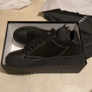 Svarta sneakers från Numeris - Snygga svarta sneakers från Numeris med kontrasterande vita sömmar. Perfekta för en stilren look.  Tog på mig dem en gång o märkte att dem inte passade and that’s it. Ända anledningen till att jag säljer dem är för att de är för små för mig, skorna har storleken 45 och jag har storlek 46. Vi kan även trade skor om du har några av samma värde. Vi kan diskutera pris 