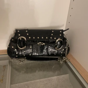 Svart axelväska med nitar - Säljer en jätte snygg svart väska med silver detaljer. Ny pris 300 kr. Priset kan diskuteras!💗