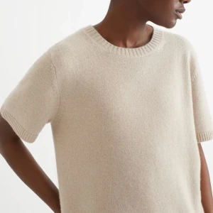 Beige stickad kortärmad tröja - Soft goat Chunky tröja som inte säljs längre, en stilren beige stickad tröja med korta ärmar och rund halsringning. Tröjan har en mjuk och enkel design som passar perfekt till många olika outfits. Intressekoll, nypris ca 2300 Den är liten i storlek