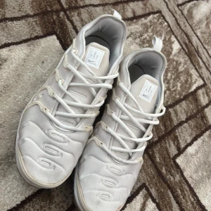 Nike Air Vapormax Plus vita sneakers - Nike Air Vapormax Plus i helvitt med futuristisk design . Ovandel i syntet och textil med unika vågformade detaljer och snörning. Perfekta för dig som vill sticka ut med en modern och sportig look. De är i väldigt bra skick ska jag säga kvitto finns med från zalando nypris 2899:-                              de passar även storlek 44-45