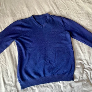 Blå sweater V-ringad - Unbranded V-ringad tunn sweater, storlek M. Har släppt lite tyg men annars i bra skick. Skön och lätt att bära till vardags.