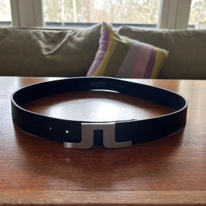 J. Lindeberg bälte - Mörkblått läder-bälte från J. Lindeberg. 85cm (W30-31). Nypris 600kr. Hör av er ifall ni har några frågor!