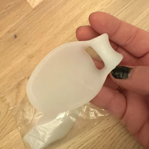 Tåseparerare, sned lilltå med fotknölskydd 2st - Tåseparerare som håller lilltån i en rakare position och den extra långa flärpen skyddar den yttre fotknölen (skräddarknuta) mot förhårdnader och liktornar.   Tåsepareraren är mjuk och behagligt att bära, vilket gör detta hjälpmedel till en många gärna använder dagligen för att bekvämt separera lilltån. Det viktigaste i behandlingen av förhårdnader och liktornar är att minska trycket på de områden där du har besvär, vilket denna tåseparerare för lilltån också gör.  Vad den gör:  Elastisk tåsepar