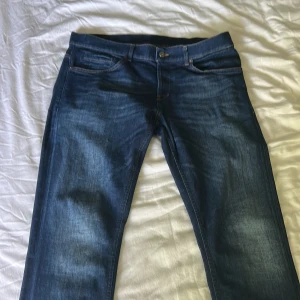 Blå dondup  - Snygga mörkblå jeans från dondup. Väldigt bra skick och använda fåtal gånger.